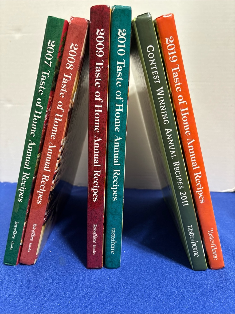 Six Taste of Home cookbooks, hardcover
